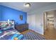 Bedroom with blue walls and a view of the dining room through an open door at 6920 Singing Dunes Ln, Las Vegas, NV 89145