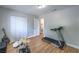Spacious bedroom with wood floors, offering closet and access to the bathroom at 6920 Singing Dunes Ln, Las Vegas, NV 89145