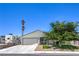 Charming single-story home with a two-car garage, desert landscaping, and covered porch seating at 6920 Singing Dunes Ln, Las Vegas, NV 89145