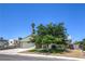 Inviting home featuring desert landscaping, charming front porch, and a convenient two-car garage at 6920 Singing Dunes Ln, Las Vegas, NV 89145