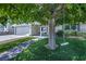 Well-maintained house front exterior with a tree and manicured lawn at 6920 Singing Dunes Ln, Las Vegas, NV 89145