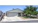 Charming single-story home with a two-car garage and well-manicured lawn at 6920 Singing Dunes Ln, Las Vegas, NV 89145