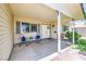 Inviting front porch with seating area, ideal for relaxing and enjoying the neighborhood at 6920 Singing Dunes Ln, Las Vegas, NV 89145