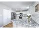 Charming kitchen with white cabinets, stainless steel appliances, and elegant countertops at 6920 Singing Dunes Ln, Las Vegas, NV 89145