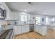 Charming kitchen featuring modern appliances, white cabinetry, and subway tile backsplash at 6920 Singing Dunes Ln, Las Vegas, NV 89145