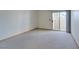 Spacious bedroom with neutral carpeting and a sliding glass door to a private balcony at 698 S Racetrack Rd # 711, Henderson, NV 89015