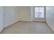Neutral bedroom with carpet flooring, bright natural light, and a view of the backyard at 698 S Racetrack Rd # 711, Henderson, NV 89015