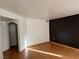Spacious living room with hardwood floors, a dark accent wall, and ample natural light at 698 S Racetrack Rd # 711, Henderson, NV 89015