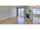 Cozy living room featuring a fireplace, sliding glass doors to a balcony, and hardwood floors at 698 S Racetrack Rd # 711, Henderson, NV 89015