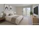 Serene main bedroom featuring a sliding glass door to a private balcony and minimalist decor at 698 S Racetrack Rd # 711, Henderson, NV 89015