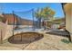 Large fenced backyard offers a trampoline, covered patio, shed, and low-maintenance landscaping at 715 Heritage Point Dr, Henderson, NV 89002
