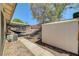 This backyard features a covered patio, storage shed, and easy-care gravel landscaping at 715 Heritage Point Dr, Henderson, NV 89002