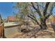 Cozy backyard featuring a shed, covered patio, mature tree, and low-maintenance desert landscaping at 715 Heritage Point Dr, Henderson, NV 89002
