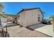 Side view of the home showing the covered patio, car, and minimal backyard landscaping at 715 Heritage Point Dr, Henderson, NV 89002
