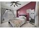 Bedroom with a large bed, gray curtains, and a full length mirror reflecting the space at 715 Heritage Point Dr, Henderson, NV 89002