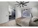 Bedroom with a large bed, black ceiling fan, and access to a modern bathroom at 715 Heritage Point Dr, Henderson, NV 89002