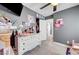 Colorful bedroom with a ceiling fan, desk, and drawers full of toys at 715 Heritage Point Dr, Henderson, NV 89002