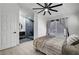 Comfortable bedroom featuring a modern ceiling fan and view of bathroom with updated walk-in shower at 715 Heritage Point Dr, Henderson, NV 89002