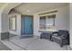 Covered front entry showing a secure screen door, desert landscaping and an exterior chair at 715 Heritage Point Dr, Henderson, NV 89002