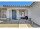 Welcoming front entry with covered porch, stylish door, desert landscaping, and exterior seating at 715 Heritage Point Dr, Henderson, NV 89002