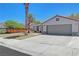 Attractive one-story home featuring a tile roof, 2-car garage, long driveway, and desert landscaping at 715 Heritage Point Dr, Henderson, NV 89002