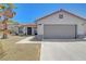 Inviting one-story home showcasing a 2-car garage, tile roof, desert landscaping and cozy entryway at 715 Heritage Point Dr, Henderson, NV 89002