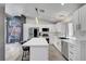 Bright kitchen with stainless steel appliances, white cabinets, and a breakfast bar at 715 Heritage Point Dr, Henderson, NV 89002