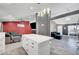 Modern kitchen with quartz countertops that opens to living and dining area at 715 Heritage Point Dr, Henderson, NV 89002