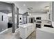 Modern kitchen with white cabinetry, stainless steel appliances, and a large island with quartz countertops at 715 Heritage Point Dr, Henderson, NV 89002