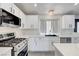 Bright kitchen showcasing stainless steel appliances, gas range, and a sleek sink area beneath the window at 715 Heritage Point Dr, Henderson, NV 89002