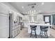 Bright kitchen with stainless steel appliances, a large island, and barstool seating for casual dining at 715 Heritage Point Dr, Henderson, NV 89002