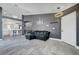Open-concept living room showcasing sleek tile floors, modern lighting, and seamless kitchen access at 715 Heritage Point Dr, Henderson, NV 89002