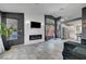 Stylish living room features an electric fireplace, tile floors, modern lighting, and backyard views at 715 Heritage Point Dr, Henderson, NV 89002