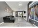 Cozy living room with sleek tile floors, modern lighting, open concept design, and backyard views at 715 Heritage Point Dr, Henderson, NV 89002