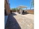 Landscaped backyard features paved areas, a pergola covered lounge area, and easy backyard access at 7160 Mineral Park Ave, Las Vegas, NV 89179