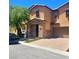 A well-maintained two-story home showcases an attached two-car garage and a charming, stone-accented entrance at 7160 Mineral Park Ave, Las Vegas, NV 89179