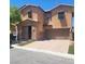 Charming two-story house with a two-car garage and a welcoming stone-accented entryway at 7160 Mineral Park Ave, Las Vegas, NV 89179