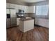 A bright kitchen features an island, stainless steel appliances, and ample counter space for culinary enthusiasts at 7160 Mineral Park Ave, Las Vegas, NV 89179