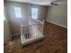 Living room with laminate flooring and a staircase with white railing at 7160 Mineral Park Ave, Las Vegas, NV 89179