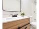 Bathroom vanity with modern fixtures and a vanity with a plant and a mirror at 744 Hubbard St, Las Vegas, NV 89110