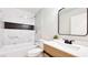 Bathroom with decorative tile accent, modern fixtures, and a vanity with a stylish mirror at 744 Hubbard St, Las Vegas, NV 89110