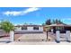 Charming single-story home with a secure front gate, well-maintained landscaping, and solar panels at 744 Hubbard St, Las Vegas, NV 89110