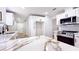 Updated kitchen featuring white cabinets, stainless steel appliances, and exquisite marble countertops at 744 Hubbard St, Las Vegas, NV 89110