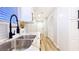 Close-up of a kitchen sink and countertops, next to a hall leading to a bright room at 744 Hubbard St, Las Vegas, NV 89110