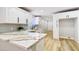 Modern kitchen with white cabinetry, marble countertops, subway tile backsplash, and stainless sink at 744 Hubbard St, Las Vegas, NV 89110