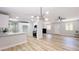 Bright living room featuring an open floor plan with modern lighting and sleek wood-look floors at 744 Hubbard St, Las Vegas, NV 89110