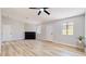 Inviting living room with stylish floors, a black brick fireplace, and a modern ceiling fan at 744 Hubbard St, Las Vegas, NV 89110