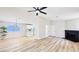 Bright living room featuring wood-look floors, modern ceiling fan, and stylish black brick fireplace at 744 Hubbard St, Las Vegas, NV 89110