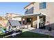 Backyard featuring a covered patio, artificial grass, a playhouse, and outdoor furniture at 7468 Wellfleet Bay Ave, Las Vegas, NV 89179