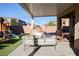 This backyard boasts a covered patio, seating, artificial lawn, and playground at 7468 Wellfleet Bay Ave, Las Vegas, NV 89179